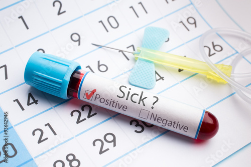 Blood test for analysis of sick / blood sample in a tube with text sick in label on a monthly planner appointments
