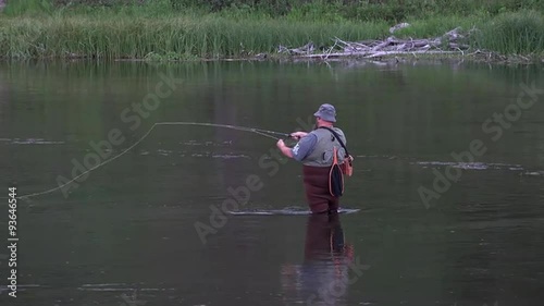 Man recreation fly fishing river in Yellowstone National Park 4K photo