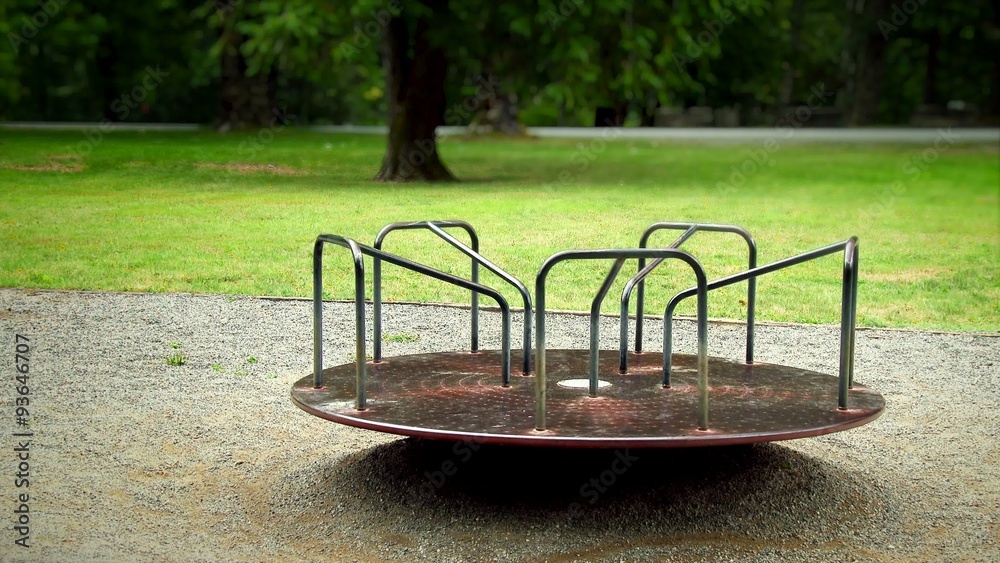 Sad empty merry go round spinning in a playground, 4K, Ultra HD