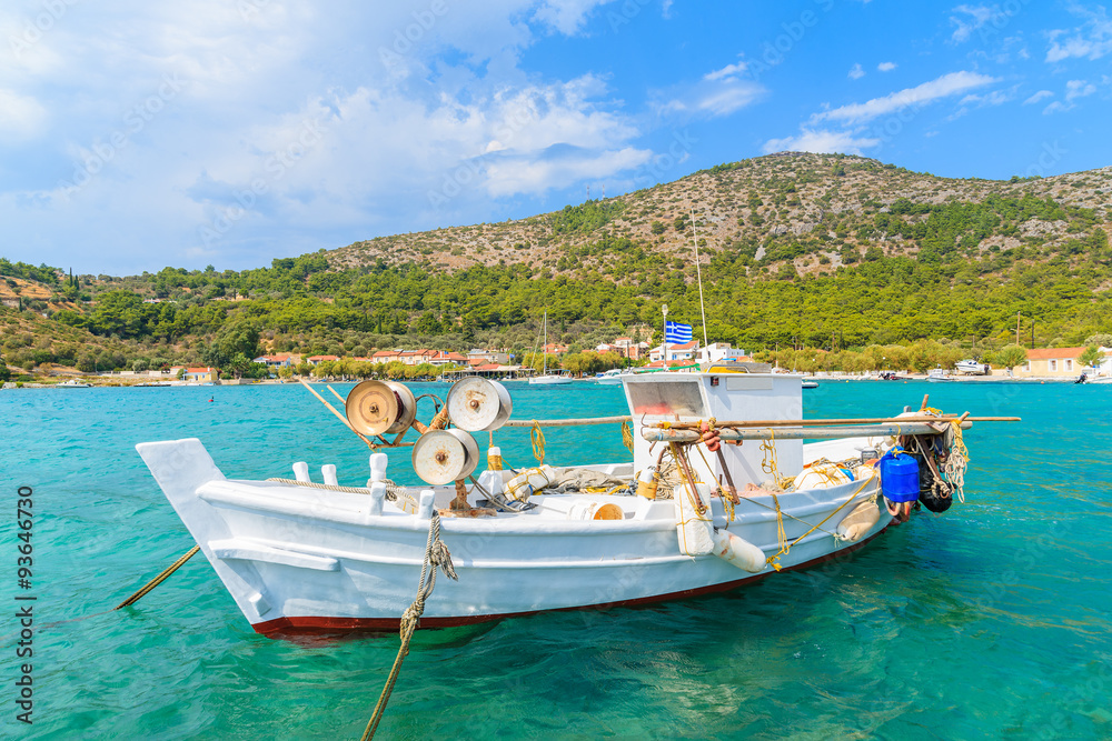 White traditional fishing boat on sea water in Posidonio bay, Samos island, Greece