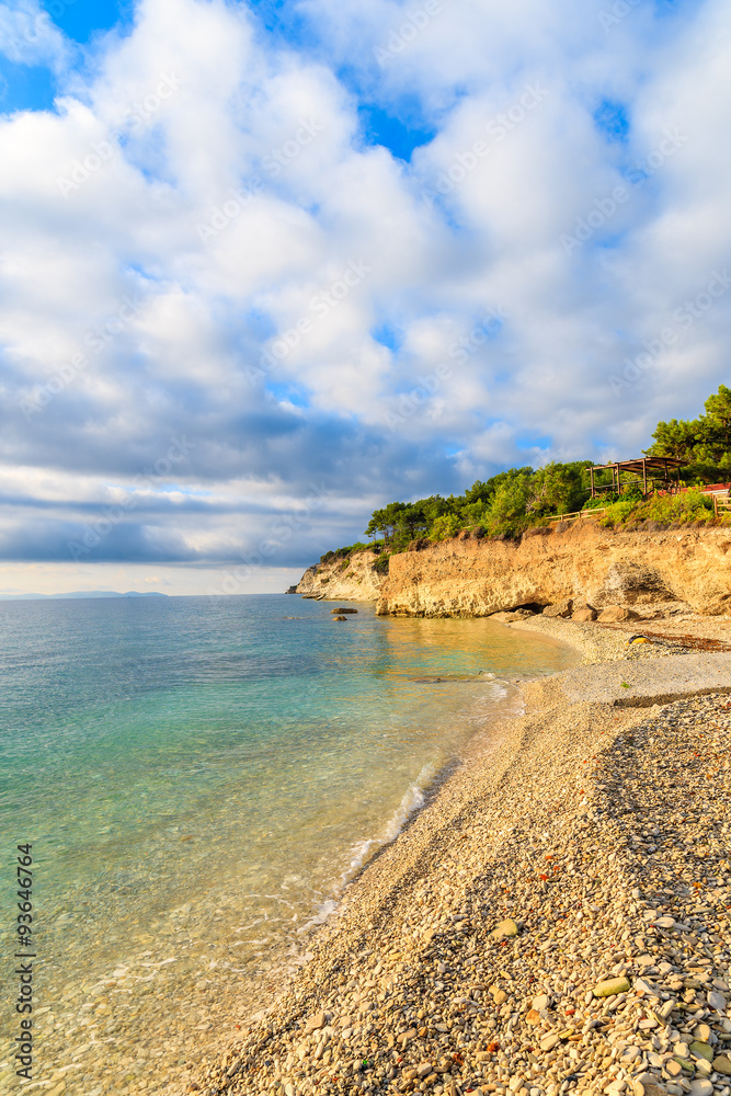 View of beach with beautiful clouds on blue sky, Samos island, Greece