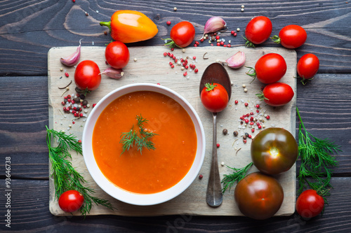 Fotografie Tomato soup on a wooden table