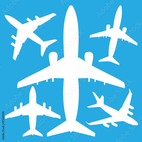 white jet airliners in the air isolated on blue background