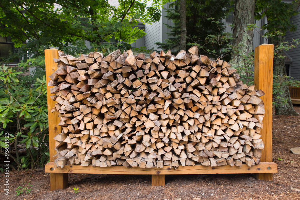 Rack of chopped logs for firewood in outdoor setting Rack of chopped logs for firewood in outdoor setting
