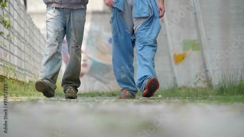 Slow motion of two workers legs walking photo