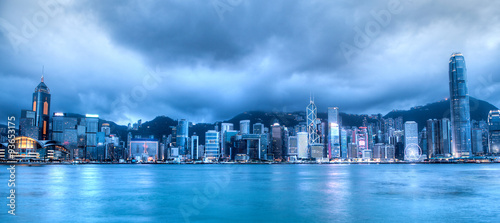 Sunset's Blue Hour Over Victoria Harbor in Hong Kong. Taken from Tsim Sha Tsui on Hong Kong Island. HDR rendering.