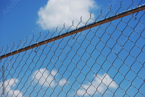 chain link fence against blue sky