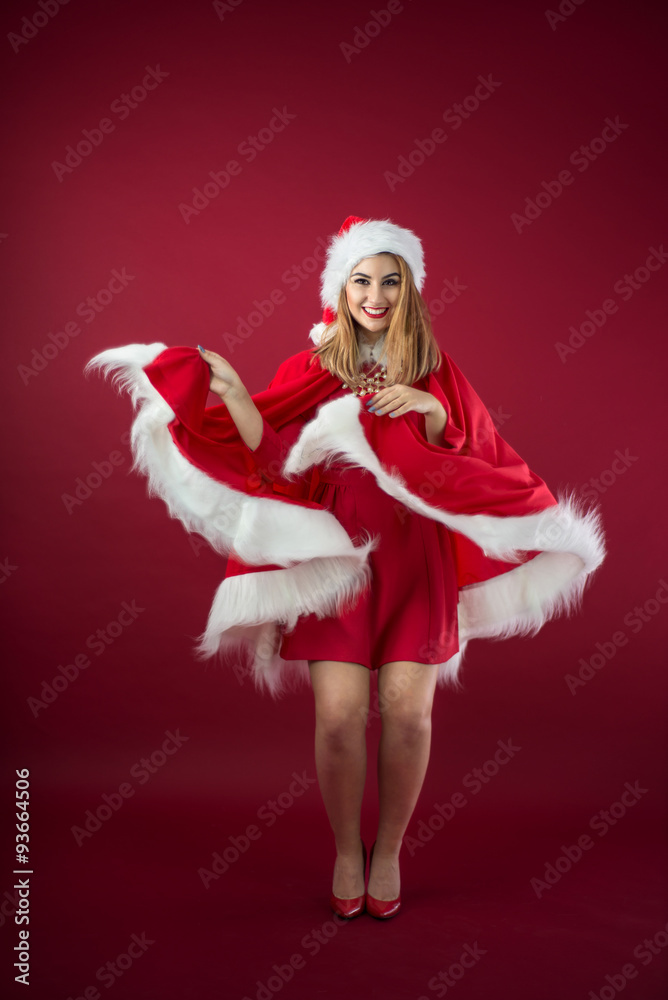 Portrait of beautiful sexy girl wearing Santa Claus clothes on red background Portrait of beautiful sexy girl wearing Santa Claus clothes on red background