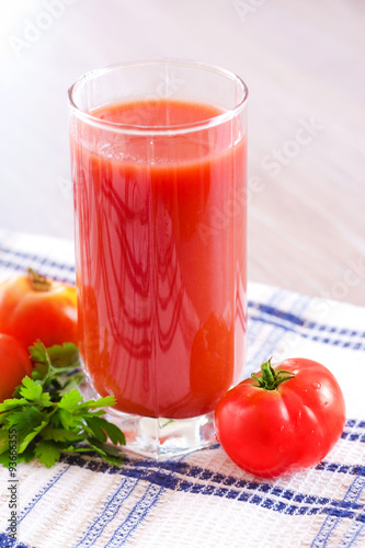 Glass of fresh tomato juice on the table