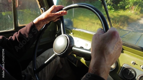 Old car goes through the countryside.