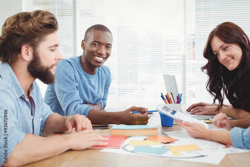 Portrait of smiling man working with coworkers Portrait of smiling man working with coworkers