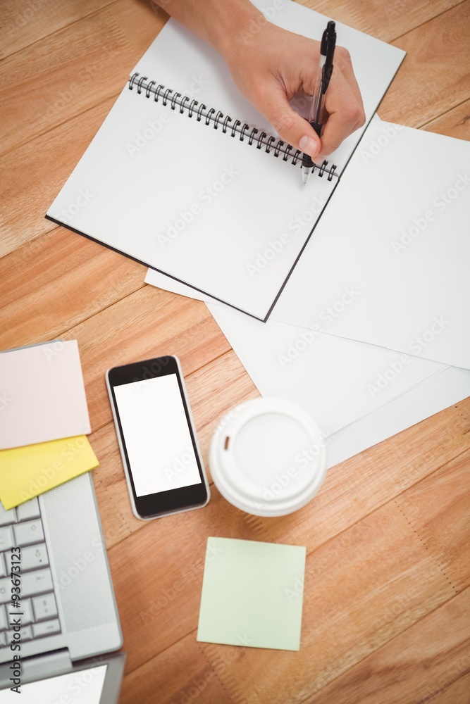 Businessman writing on spiral notebook Businessman writing on spiral notebook
