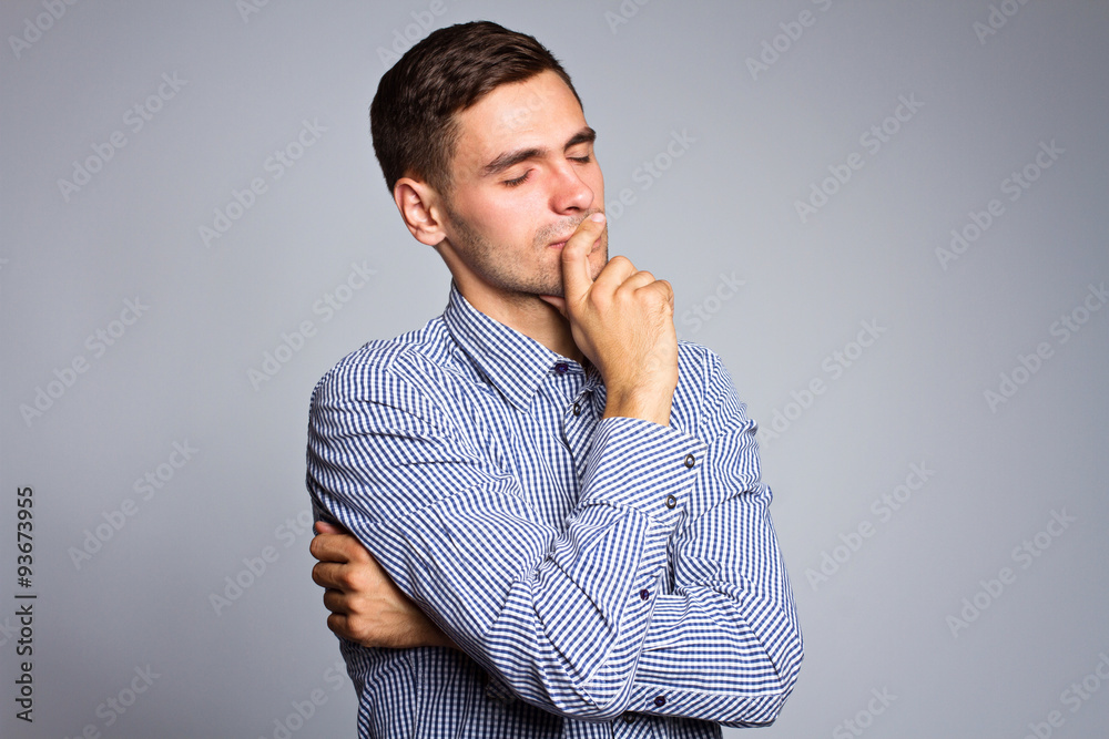 Portrait of thinking businessman on gray background Portrait of thinking businessman on gray background