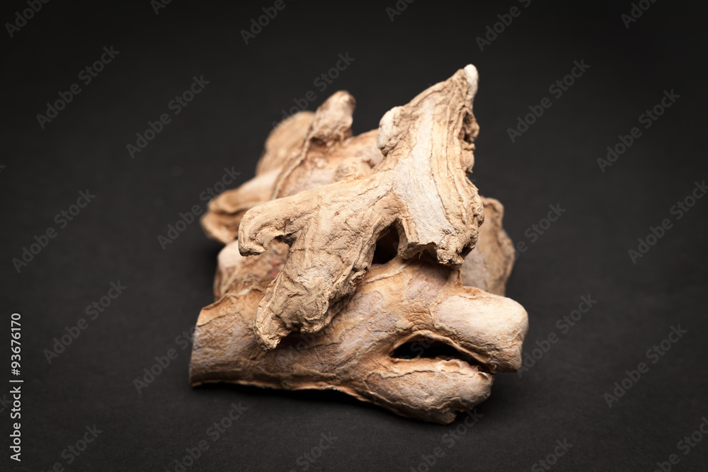 Organic Dried Ginger root or Sonth (Zingiber officinale) on dark background. Organic Dried Ginger root or Sonth (Zingiber officinale) on dark background.