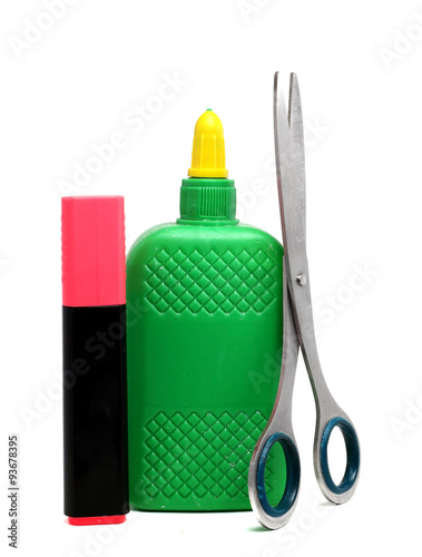 bottle of glue, scissors and a pink marker on a white background