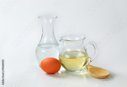 water, oil, egg and wooden spoon