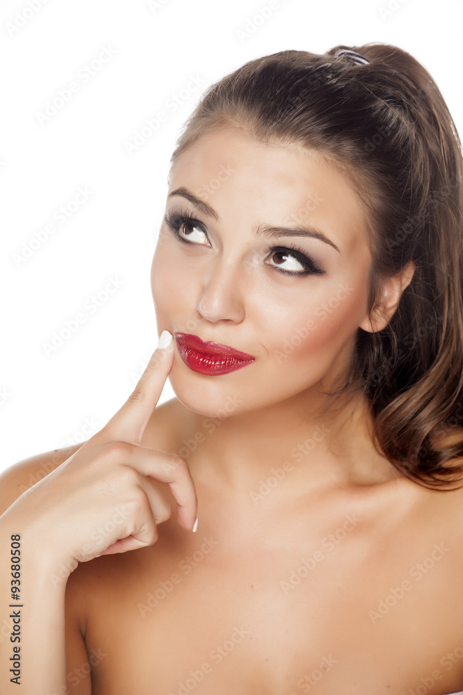 beautiful woman thinking and touching her chin with one finger beautiful woman thinking and touching her chin with one finger