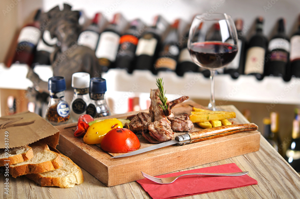 Beef steak barbecue with fried potato and red wine on wood table