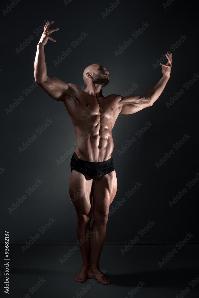 man posing in the studio on a dark background man posing in the studio on a dark background