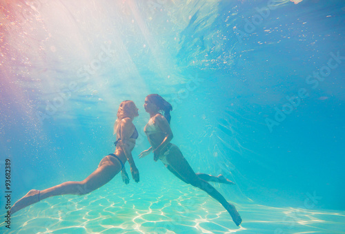 Two Young women swimming underwater