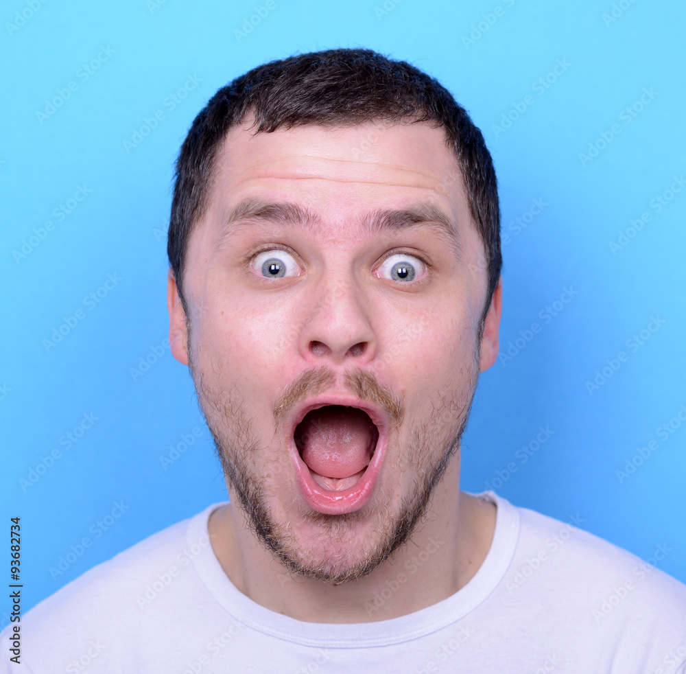 Portrait of man with funny face against blue background Portrait of man with funny face against blue background