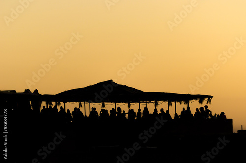 People on a beach party event in sunset. Dancing and partying. photo