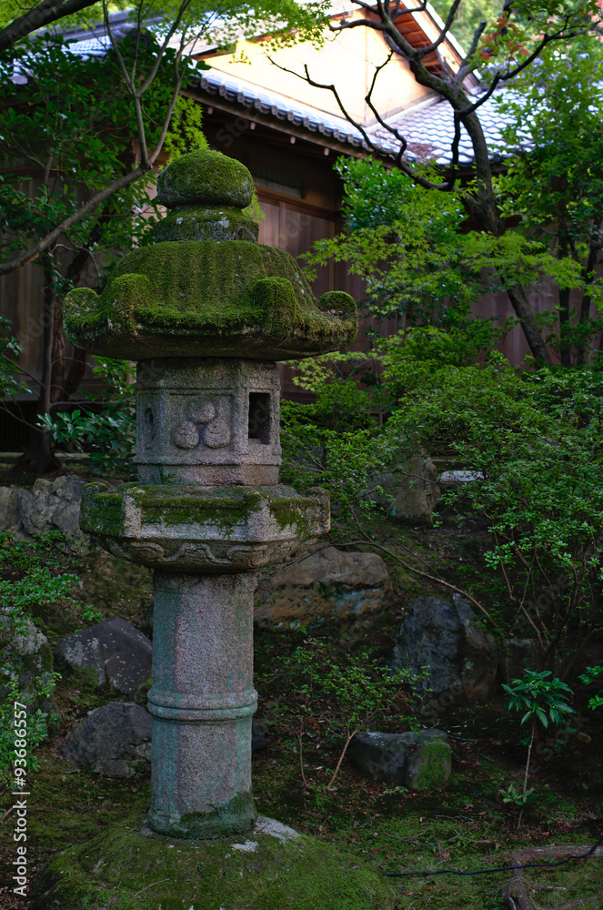 Stone lantern covered in musk