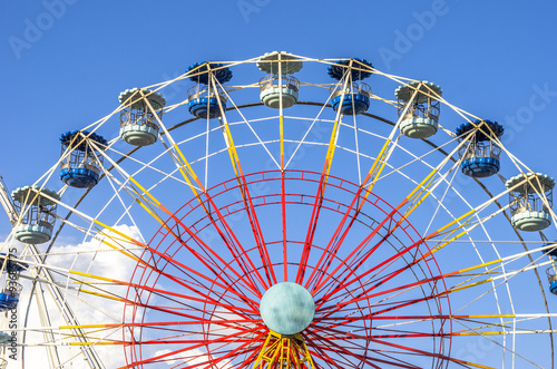Ferris wheel on white on blue skype and cloud.
