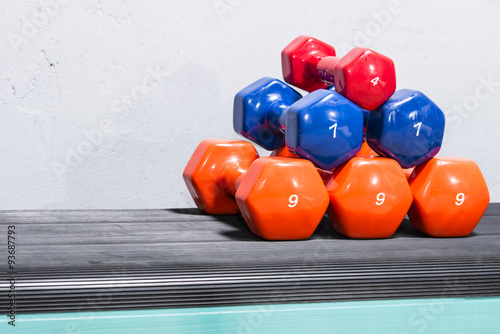 Dumbbells on the floor, at the gym hall.

