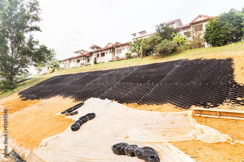 Photo Slope erosion control with grids and earth on steep slope