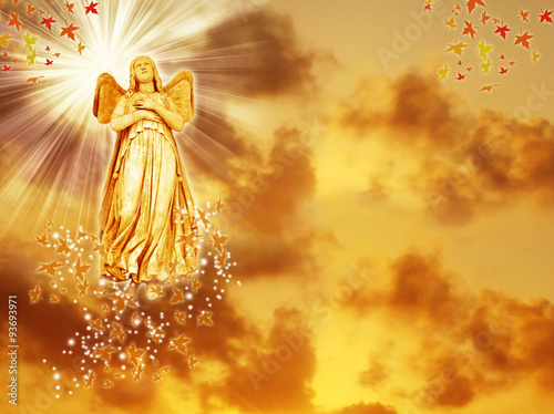 an angel statue over mystical sky with divine light and stars