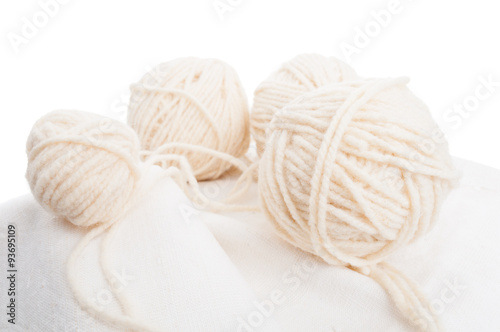 Balls of soft wool on cotton fabric