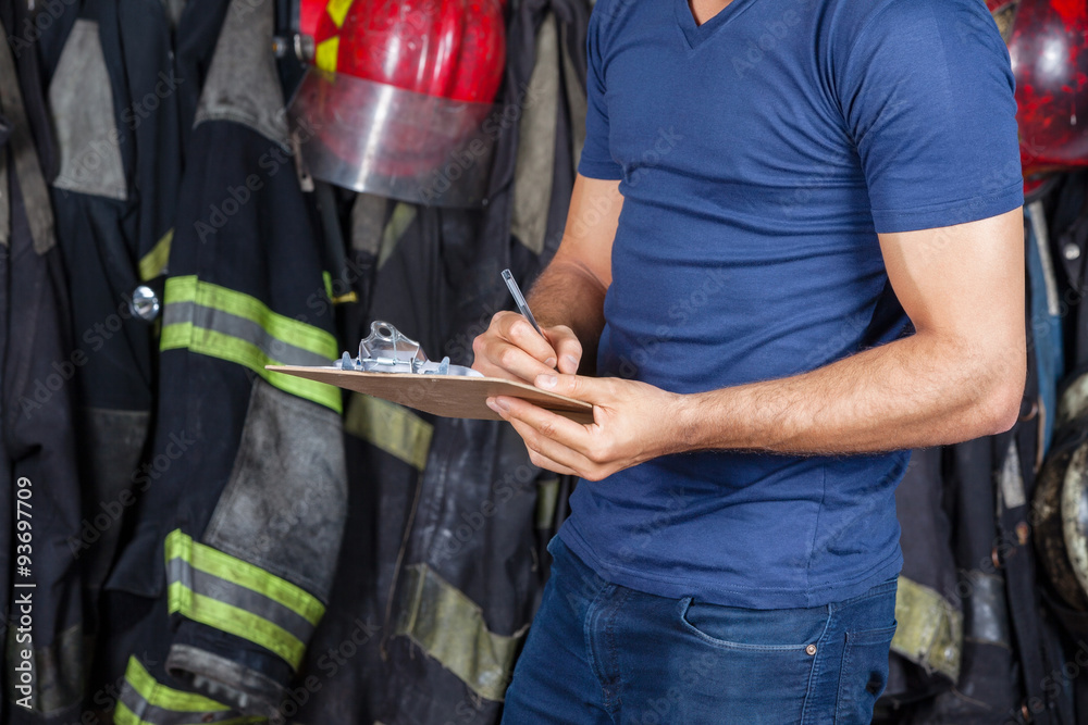 Fototapeta premium Firefighter Writing On Clipboard