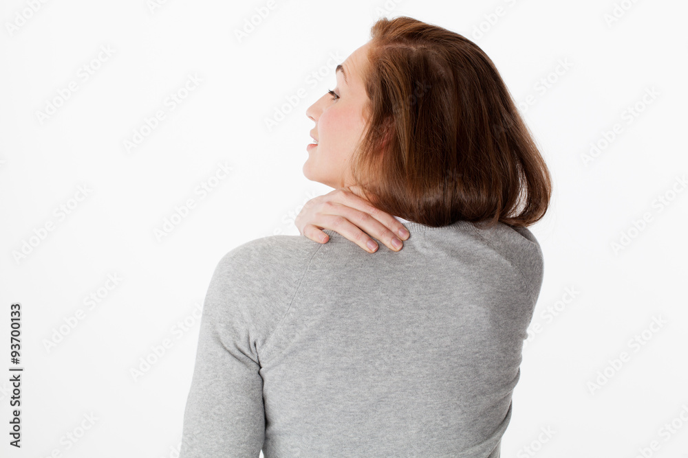 20s woman in back view with shoulders and neck tension