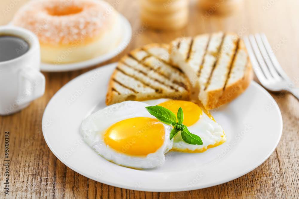 Breakfast with fried eggs, coffee and dessert on table. Healthy food Breakfast with fried eggs, coffee and dessert on table. Healthy food
