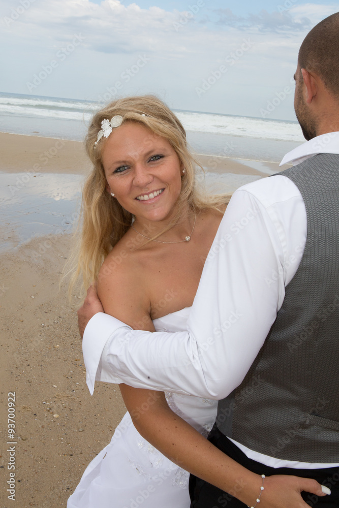 Beautiful couple on the beach in wedding dress