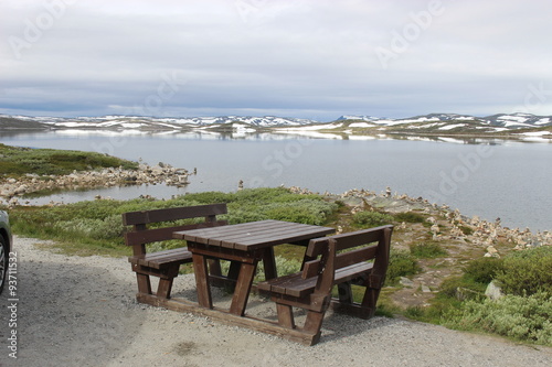 The Hardangervidda Plateau in Hallingskarvet National Park, Norway, Europe, with lake Ustevatn. In August, there is still snow on the mountains.