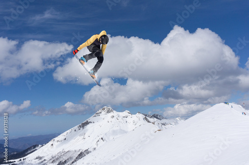 Flying snowboarder on mountains