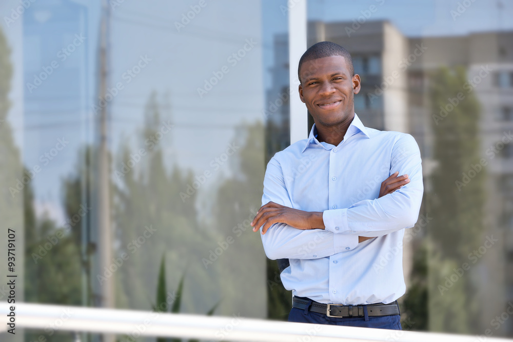 Handsome African American businessman near business centre Handsome African American businessman near business centre