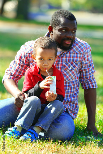 Father and son playing on grass in the park © Africa Studio