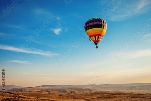 Air balloon over the field with blue sky