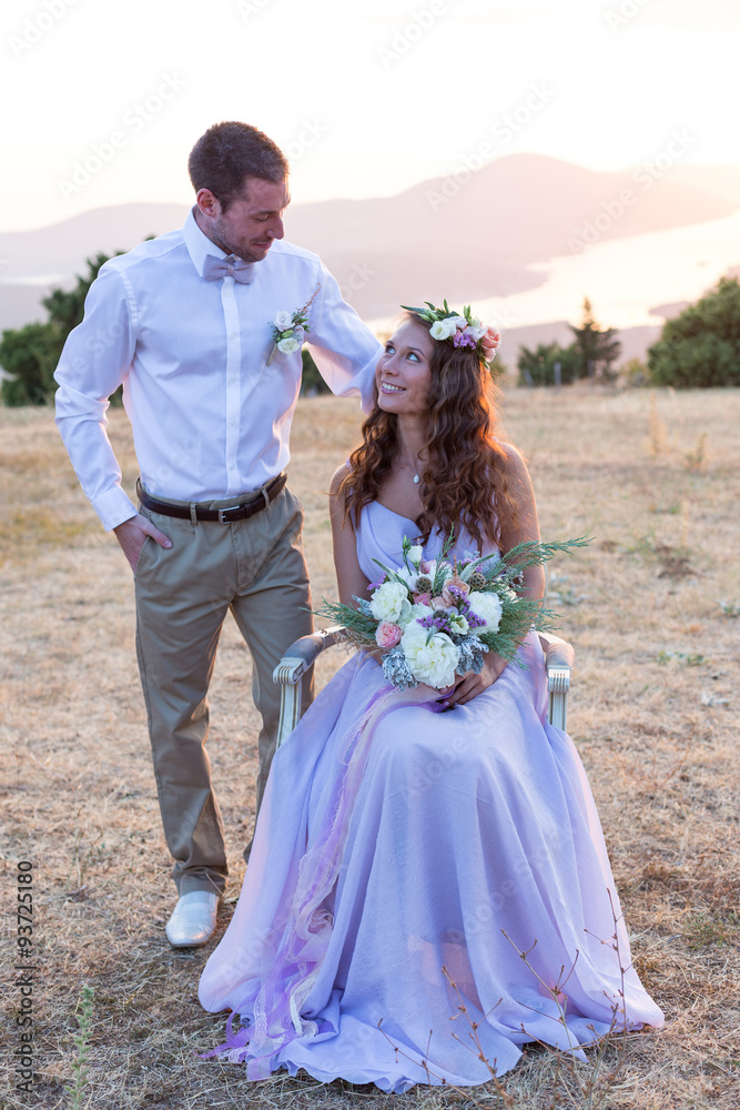Fototapeta premium the bride and groom posing at sunset
