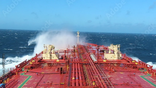 Big ship crashes a waves in the sea.