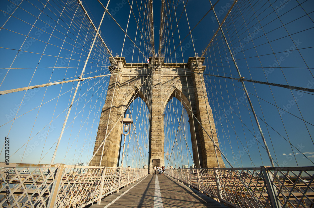 Fototapeta premium Walkway on the Brooklyn Bridge with blue sky, New York City, USA