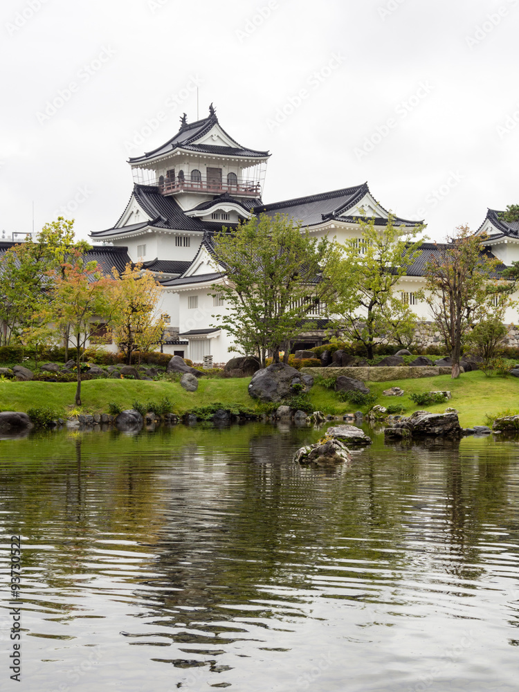 Japanese garden with pond and white castle