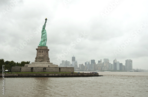 Statue of Liberty and New York City Skyline in background on a rainy day, Manhattan, New York City, USA