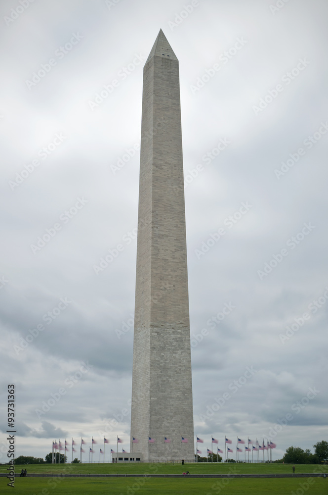 Washington Monument and circle of flags in front of cloudy sky, HDR, Washington D.C., USA