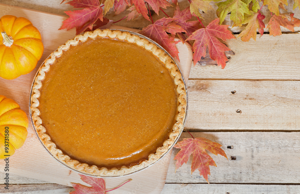Fall Pumpkin Pie With Colorful Leaves and Pumpkins