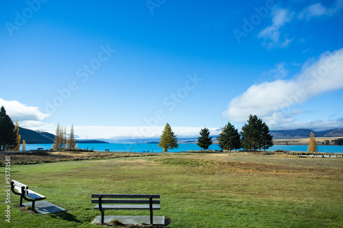 Viewpoint of the Lake Tekapo has a beautiful sight of the lawn and distinctive blue water. The Lake Tekapo is located at the center of the South Island of New Zealand.