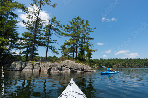 Woman Kayaking on Northern Lake